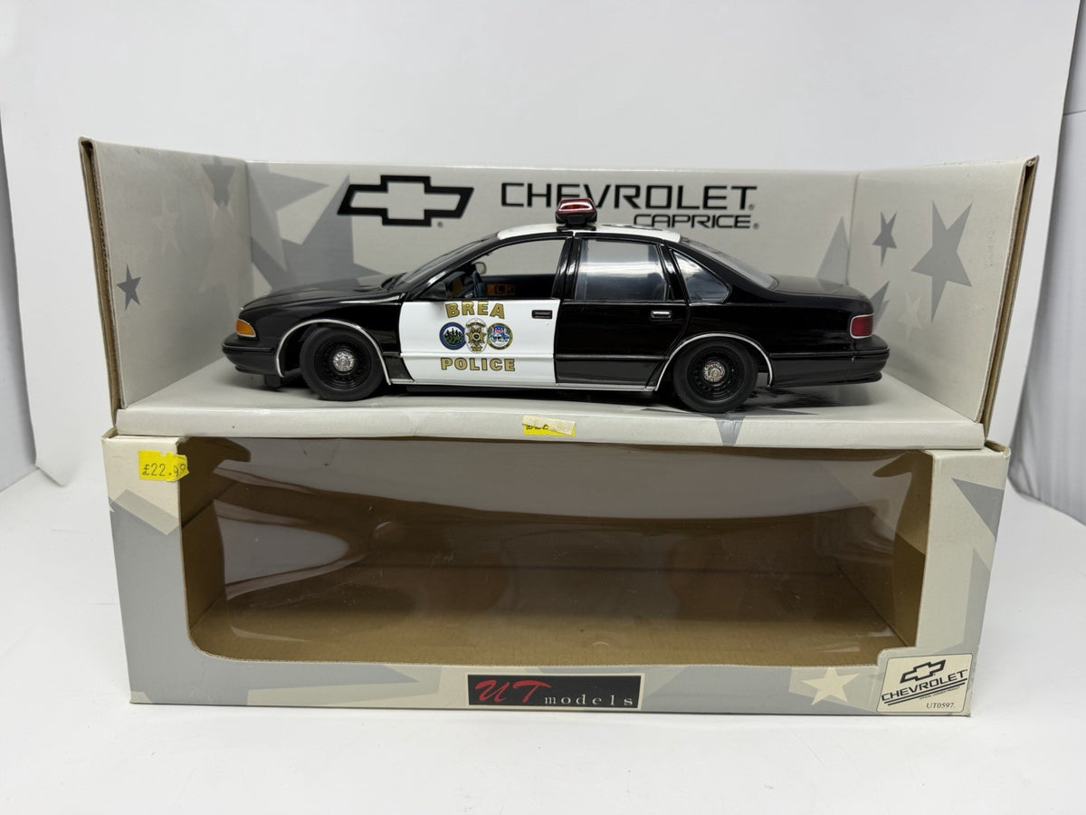 UT Models 1:18 Chevrolet Caprice Brea Police die-cast model displayed on its box base with the window box below