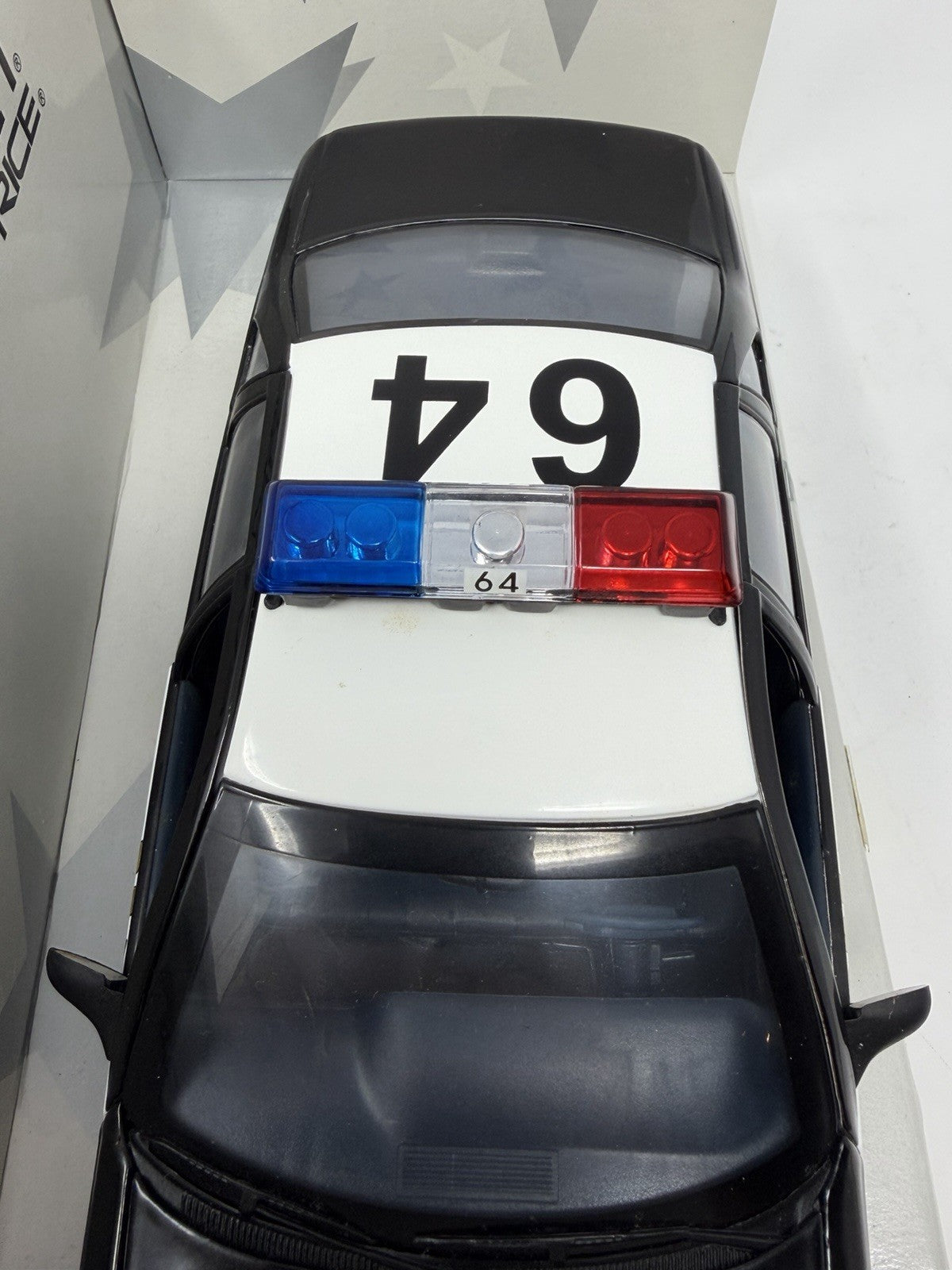 UT Models 1:18 Chevrolet Caprice Brea Police, roof number 64 and red, white and blue light bar from above
