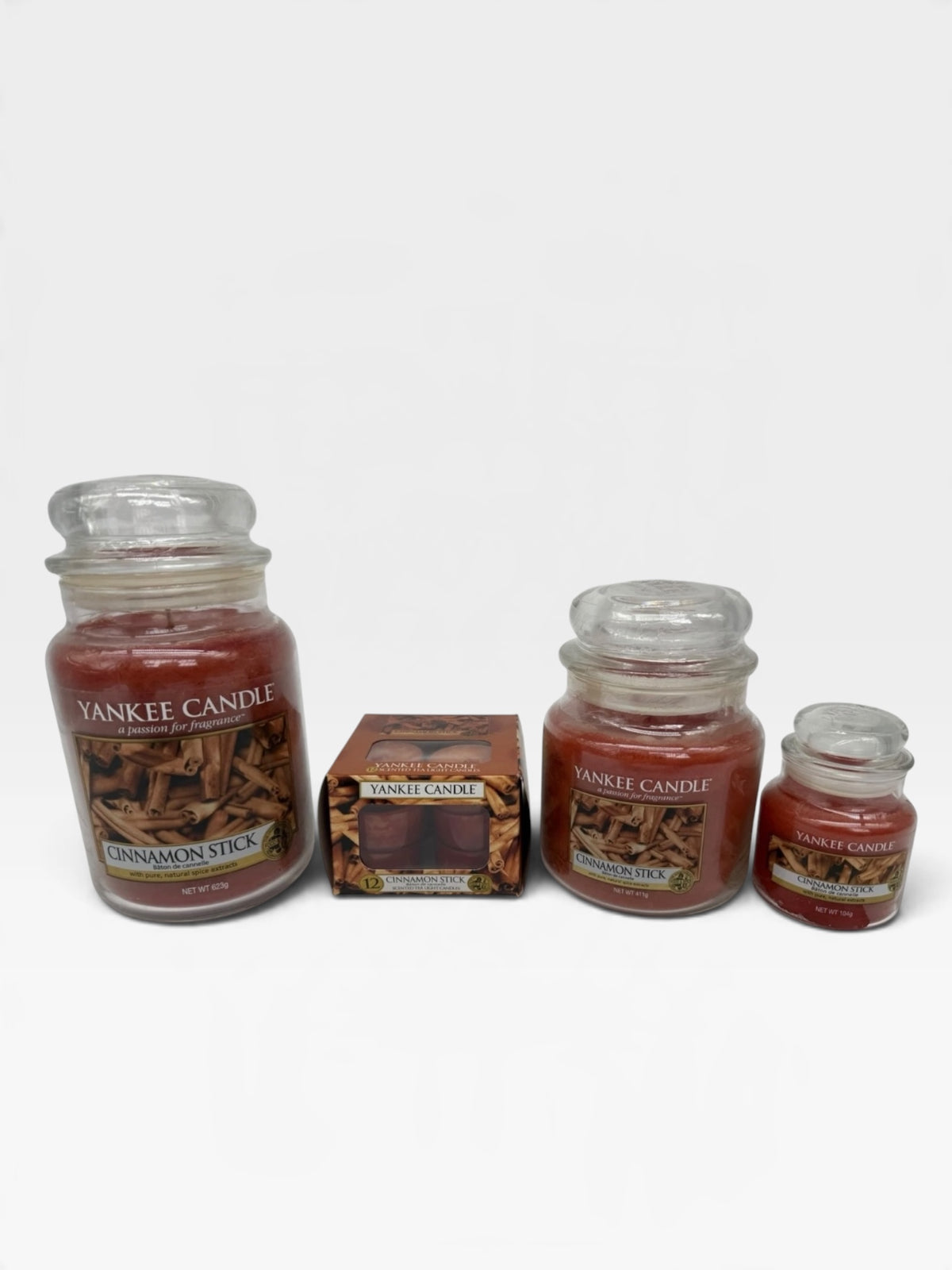 Yankee Candle Cinnamon Stick bundle with three jar candles and twelve tea lights, featuring warm cinnamon spice scent for home ambiance.